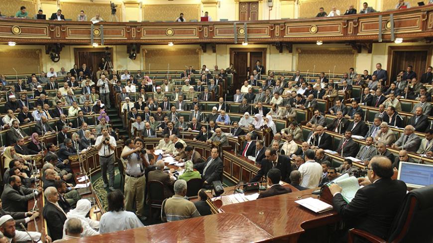 Parliament members talk during a session at the parliament building in Cairo, July 10, 2012. Egypt's Islamist-led parliament reconvened on Tuesday in an open challenge to the generals who dissolved the assembly last month, stirring up tensions with the military just 10 days into Mohamed Mursi's presidency. REUTERS/Stringer (EGYPT - Tags: POLITICS) - RTR34SOH