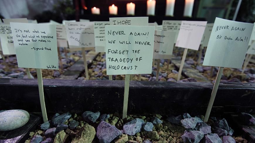 School children from Turkey's Jewish community leave notes on a symbolic railway track during a commemoration event on International Holocaust Remembrance Day at Etz Ahayim Synagogue in Istanbul January 27, 2013. The International Day of Commemoration, which was designated by the United Nations General Assembly to honour Holocaust victims, occurs annually on January 27. REUTERS/Murad Sezer (TURKEY - Tags: POLITICS RELIGION ANNIVERSARY) - RTR3D1Z7