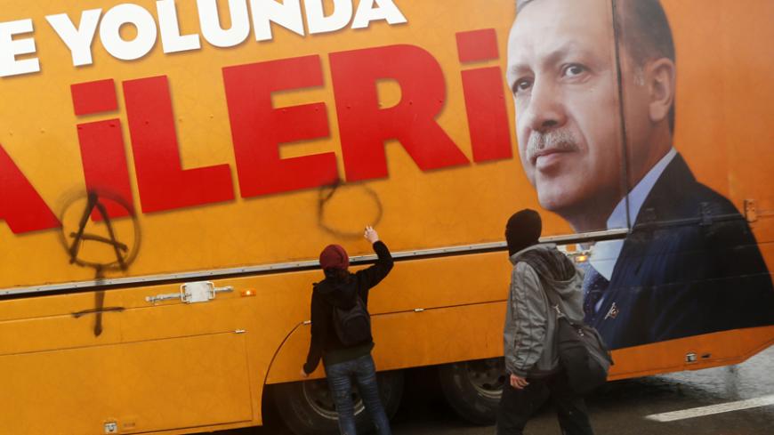 Protesters paint a truck of Turkey's ruling AK Party (AKP) during a demonstration against the opening of a new road including a part of the Middle East Technical University campus in Ankara February 25, 2014. Turkish Prime Minister Tayyip Erdogan on Tuesday opened the road across the Middle East Technical University campus, during the construction of which a large number of trees were uprooted in the area.  REUTERS/Umit Bektas (TURKEY - Tags: POLITICS CIVIL UNREST CRIME LAW) - RTR3FPP0