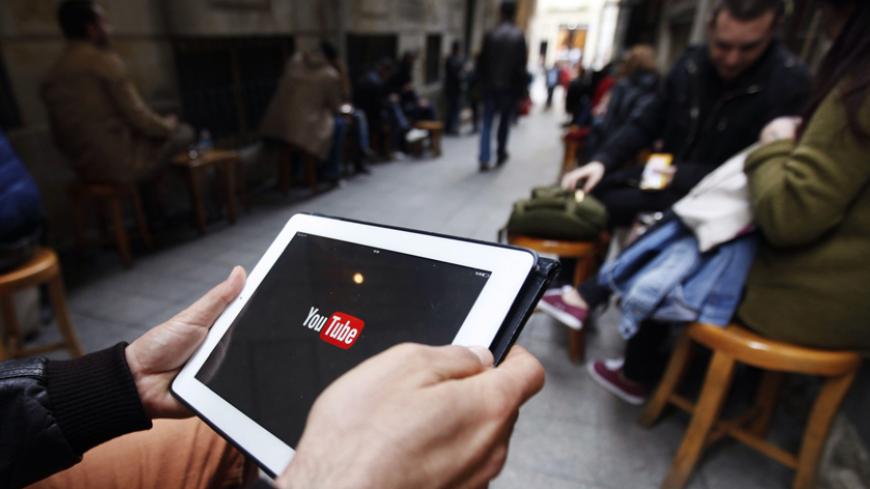 A man tries to get connected to the youtube web site with his tablet at a cafe in Istanbul March 27, 2014. The Turkish telecoms authority TIB said on Thursday it had taken an "administrative measure" against YouTube, a week after it blocked access to microblogging site Twitter. REUTERS/Osman Orsal (TURKEY - Tags: POLITICS CIVIL UNREST SCIENCE TECHNOLOGY) - RTR3IUSP