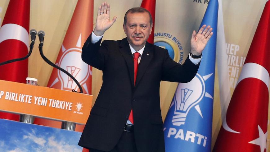 Turkey's Prime Minister Tayyip Erdogan greets his supporters during the Extraordinary Congress of the ruling AK Party (AKP) to choose a new leader of the party, ahead of his inauguration as president, in Ankara August 27, 2014. Turkish president-elect Erdogan said on Wednesday he would ask incoming prime minister Ahmet Davutoglu to form a new government on Thursday, and a new cabinet of ministers would be announced the following day. REUTERS/Umit Bektas (TURKEY - Tags: POLITICS) - RTR43YHW