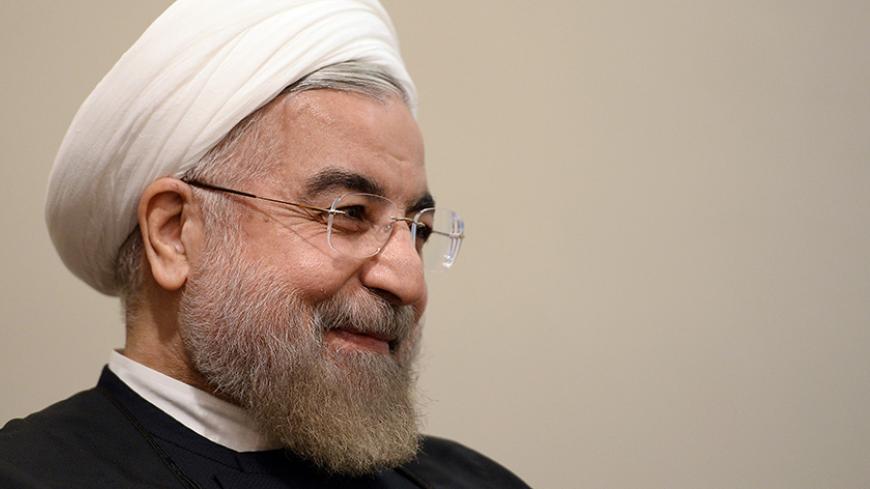 Iran's President Hassan Rouhani smiles during a meeting with U.N. Secretary-General Ban Ki-moon on the sidelines of the U.N. General Assembly in New York September 23, 2014. REUTERS/Jewel Samad/Pool (UNITED STATES - Tags: POLITICS ENVIRONMENT) - RTR47FN9