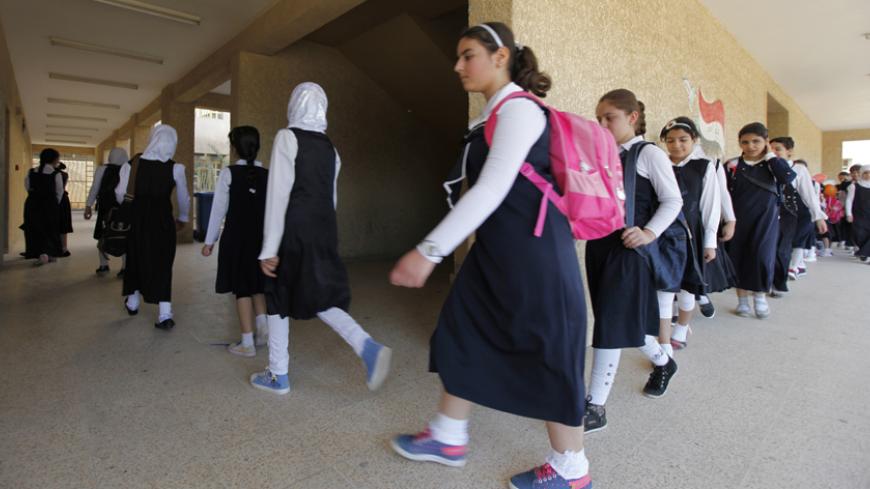 Students attend the first day of the new school term in Baghdad October 22, 2014. Children went back to school at the start of the new term on Wednesday amid increased security in Baghdad, as conflict rages in the country.  REUTERS/Ahmed Saad (IRAQ - Tags: EDUCATION SOCIETY TPX IMAGES OF THE DAY) - RTR4B4OY
