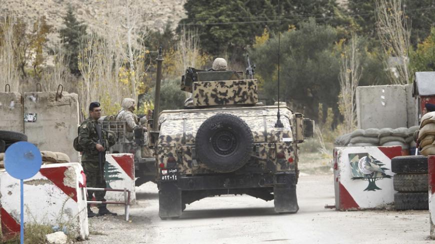 Lebanese military soldiers man a checkpoint, near the site of an ambush where gunmen killed at least six Lebanese soldiers, in the mountainous border town of Ras Baalbek December 3, 2014. Gunmen killed at least six Lebanese soldiers when they attacked an army patrol near the border with Syria on Tuesday, the army and a Lebanese security source said. The source said the gunmen crossed from Syria to the mountainous border town of Ras Baalbek after dark and ambushed the patrol. Clashes between gunmen and a spe