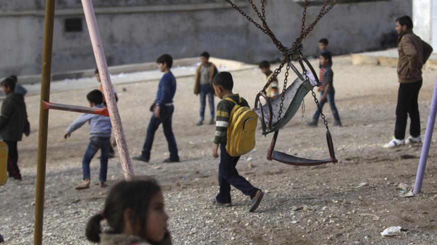 Children who were internally displaced from Hama and Idlib, walk in a makeshift school playground within a refugee camp beside the Syrian-Turkish border in Qtma town, Idlib countryside December 18, 2014. Picture taken December 18, 2014. 
REUTERS/Khalil Ashawi (SYRIA - Tags: POLITICS CIVIL UNREST CONFLICT) - RTR4IO28