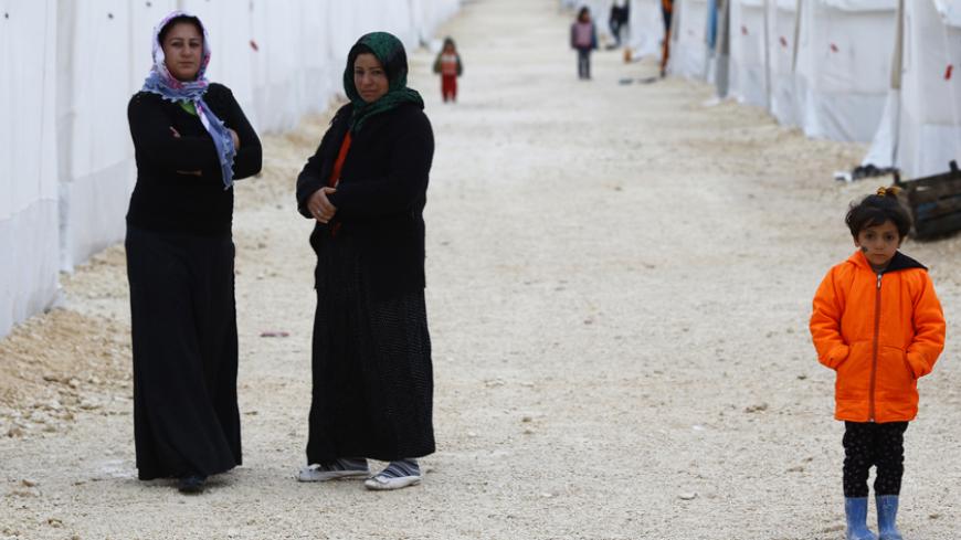 Kurdish refugees from the Syrian town of Kobani stand in front of their tent at a refugee camp in the border town of Suruc, Sanliurfa province January 31, 2015. The United States and its allies carried out 27 air strikes against Islamic State militants in Iraq and Syria since early Friday, the Combined Joint Task Force leading the operation reported on Saturday. Ten of the 17 strikes in Iraq hit near the oil city of Kirkuk, it said. In Syria, Islamic State targets near the border town of Kobani were attacke