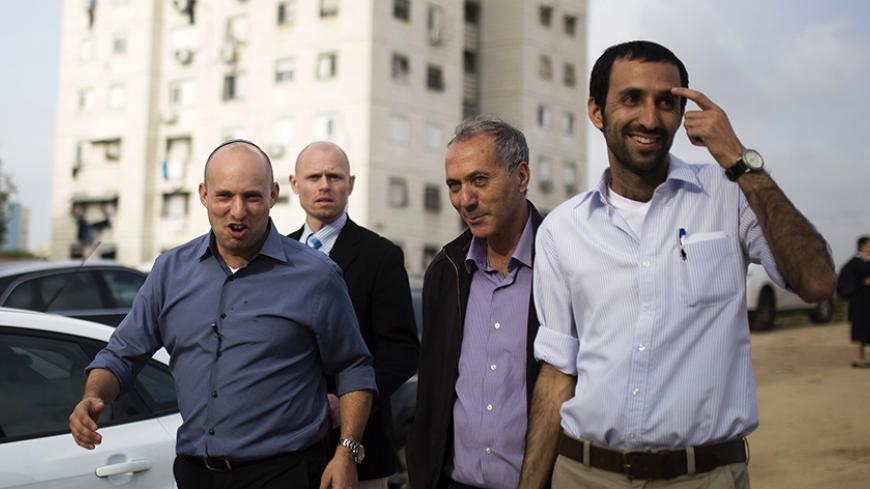 Israel's Economy Minister Naftali Bennett (L), head of far-right Jewish Home party, arrives at a shopping mall to campaign in the southern city of Ashkelon February 3, 2015. Young and ambitious, with a ready smile and a quick wit, Israeli far right leader Bennett is on a mission to prevent the creation of a Palestinian state. If, as widely expected, he takes on defence or another key portfolio after next month's election, that mission will take a big step closer to fulfilment, something his critics say coul