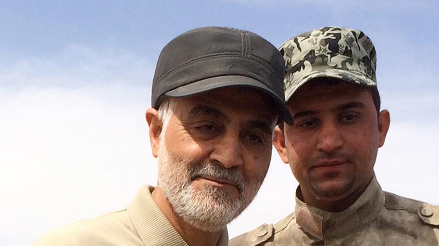 Iranian Revolutionary Guard Commander Qassem Soleimani (L) stands at the frontline during offensive operations against Islamic State militants in the town of Tal Ksaiba in Salahuddin province March 8, 2015. Picture taken March 8, 2015.  REUTERS/Stringer (IRAQ - Tags: CIVIL UNREST CONFLICT POLITICS) - RTR4TTZ2