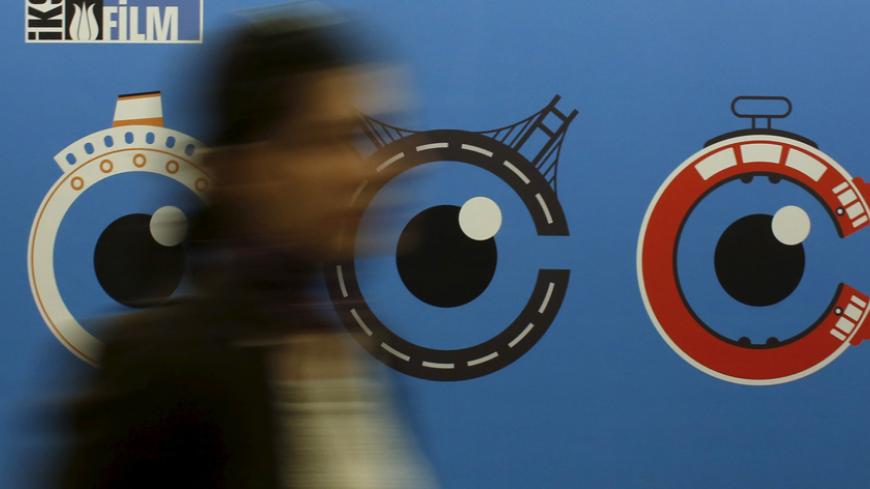 A woman walks past by a banner of Istanbul Film Festival at Atlas movie theatre in Istanbul April 14, 2015. Nearly two dozen filmmakers and a group of international critics have pulled out of the Istanbul Film Festival after the government prevented the screening of a film about Kurdish militants, in the latest outcry over censorship in Turkey. At least 22 films from the roughly 200 submitted were withdrawn this week and the festival competition cancelled, according to organisers, over "Kuzey/Bakur" (the Tu