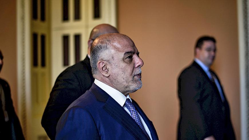 Iraqi Prime Minister Haider al-Abadi walks to a meeting with the Senate leadership at the U.S. Capitol in Washington April 15, 2015. REUTERS/James Lawler Duggan - RTR4XHQA