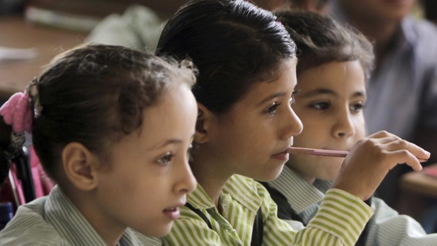 Students attend a class on the first day of their new school year at a government school in Giza, south of Cairo September 22, 2013. Students resumed their studies at the beginning of the new academic year this weekend amid parental concerns of a possible lack of security after the summer vacation ends. REUTERS/Mohamed Abd El Ghany  (EGYPT - Tags: POLITICS EDUCATION) - RTX13UK0
