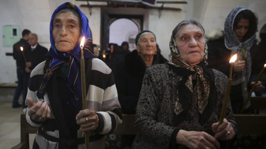 Syriac Christians from Turkey and Syria attend a mass at the Mort Shmuni Syriac Orthodox Church in the town of Midyat, in Mardin province of southeast Turkey February 2, 2014. Despite the empty streets of Midyat, the historical Mort Shmuni Syriac Orthodox Church is overcrowded with a community of three hundred people, mostly children. For longer than two years, not only the native Turkish Christian citizens of Midyat, but also the Syriac families escaping the bloody war in Syria just across the border are j