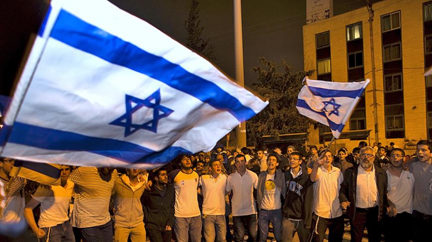 Israelis dance with Israeli national flags during celebrations marking Israel's 67th Independence Day in Jerusalem April 22, 2015. REUTERS/Ronen Zvulun - RTX19VBT
