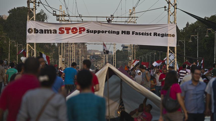 Egyptian demonstrators gather outside the presidential palace in Cairo during a protest calling for the ouster of President Mohamed Morsi on July 1, 2013. Egypt's armed forces warned that it will intervene if the people's demands are not met within 48 hours, after millions took to the streets to demand the president's resignation. AFP PHOTO / KHALED DESOUKI (Photo credit should read KHALED DESOUKI/AFP/Getty Images)