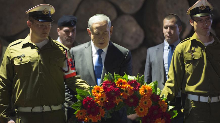 JERUSALEM, ISRAEL - APRIL 16: (ISRAEL OUT) In this handout from the Israeli GPO, Prime Minister Benjamin Netanyahu lays a wreath during a ceremony to mark Holocaust Remembrance Day at the Yad Vashem Museum on April 16, 2015 in Jerusalem, Israel. Traffic stopped and people stood to attention as a two minutes silence was observed in Israel, with sirens sounding across the country to mark the annual Holocaust Remembrance Day. (Photo by Amos Ben Gershom/GPO via Getty Images)