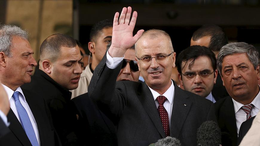 Palestinian Prime Minister Rami Hamdallah waves during a news conference in Gaza City March 25, 2015. Hamdallah, who arrived to Gaza on Wednesday, urged donor countries to fulfill their financial obligations for the reconstruction of Gaza. REUTERS/Mohammed Salem
- RTR4UTH1