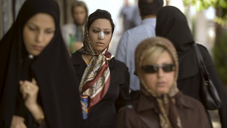 Arezoo Abassi (C) walks along a street in Tehran June 24, 2007, three weeks after undergoing nose surgery.  REUTERS/Caren Firouz  (IRAN) - RTR1R44J
