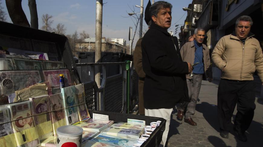 EDITORS' NOTE: Reuters and other foreign media are subject to Iranian restrictions on leaving the office to report, film or take pictures in Tehran.

A money changer waits for customers in Tehran's business district January 7, 2012. REUTERS/Raheb Homavandi  (IRAN - Tags: BUSINESS) - RTR2VZCM