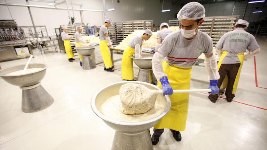 Workers prepare helva, a traditional Turkish sweet prepared with sesame oil, at Konya Seker Sugar Factory in Cumra, a small town about 50km (31 miles) south of the central Anatolian city of Konya January 27, 2012. REUTERS/Umit Bektas (TURKEY - Tags: BUSINESS FOOD) - RTR2WYOL