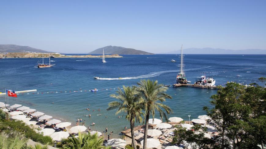 Holidaymakers rest at a beach in the resort town of Bodrum July 14, 2014. As families splash in the sea and lounge in the sun, thoughts of politics and civic duty are a world away for most Turks holidaying on the Aegean and Mediterranean coasts. Only the most committed opponents of Prime Minister Tayyip Erdogan leave the beach to queue in a sweltering council building nearby to register to vote in next month's presidential election to prevent what they see as the country's slide towards authoritarianism. Th