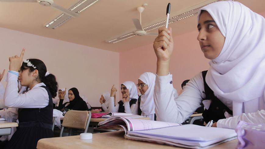 Students attend class in the Nafit 1, a modern school built with the aid of a grant from Kuwait, in Basra, southeast of Baghdad November 2, 2014. A country that used to have one of the finest education systems in the Middle East is struggling to provide school students with the basic opportunity to learn. In the southern port city of Basra, many school buildings are in a dilapidated state. Large numbers of children are attending schools that lack even basic water or sanitation facilities, have crumbling wal