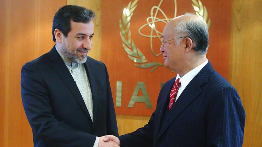 International Atomic Energy Agency (IAEA) Director General Yukiya Amano (R) welcomes Iran's chief nuclear negotiator Abbas Araghchi in his offfice at the IAEA headquarters in Vienna February 24, 2015. REUTERS/Heinz-Peter Bader (AUSTRIA - Tags: POLITICS ENERGY) - RTR4QWK7
