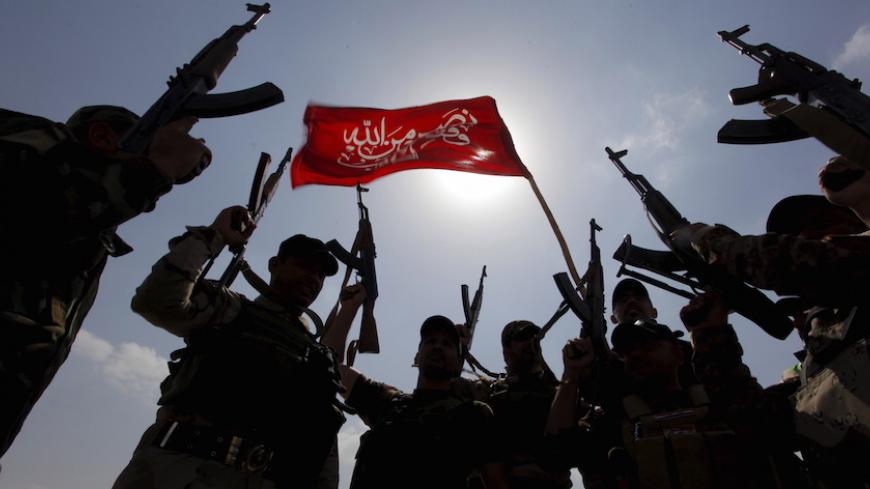 Hashid Shaabi (Popular Mobilisation) forces allied with Iraqi forces chant slogans against the Islamic State in Tikrit March 30, 2015. Iraqi security forces continued their offensive against Islamic State militants on the outskirts of Tikrit on Monday, in an operation slowed by bombs and booby traps. REUTERS/Alaa Al-Marjani - RTR4VI58