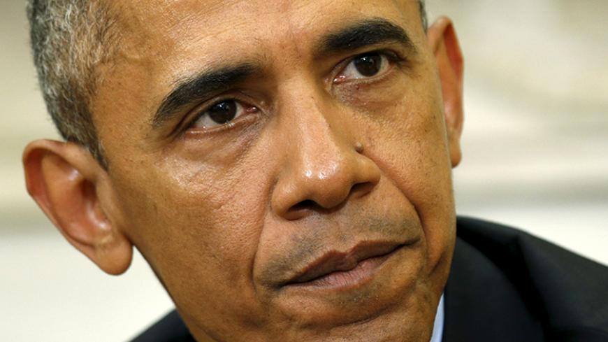 U.S. President Barack Obama pauses while speaking during his meeting with U.S. Attorney General Loretta Lynch in the Oval Office of the White House in Washington May 29, 2015. REUTERS/Kevin Lamarque - RTR4Y31T