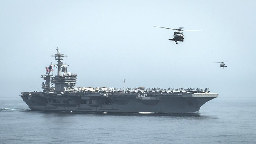 Helicopters fly from the aircraft carrier USS Theodore Roosevelt (CVN 71) during a resupply mission with the aircraft carrier USS Carl Vinson (CVN 70) in this U.S. Navy handout picture taken in the Gulf of Oman April 13, 2015 and released April 20, 2015. The U.S. Navy sent the carrier USS Theodore Roosevelt and its escort cruiser, USS Normandy, from the Gulf into the Arabian Sea on Sunday.  Army Colonel Steve Warren, a Pentagon spokesman, denied reports the ships were on a mission to intercept Iranian arms 
