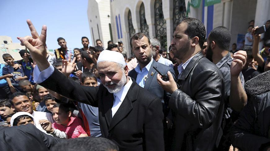 Senior Hamas leader Ismail Haniyeh waves to people after attending Friday prayers at Tebah mosque in Rafah in the southern Gaza Strip May 1, 2015. REUTERS/Ibraheem Abu Mustafa - RTX1B4H7