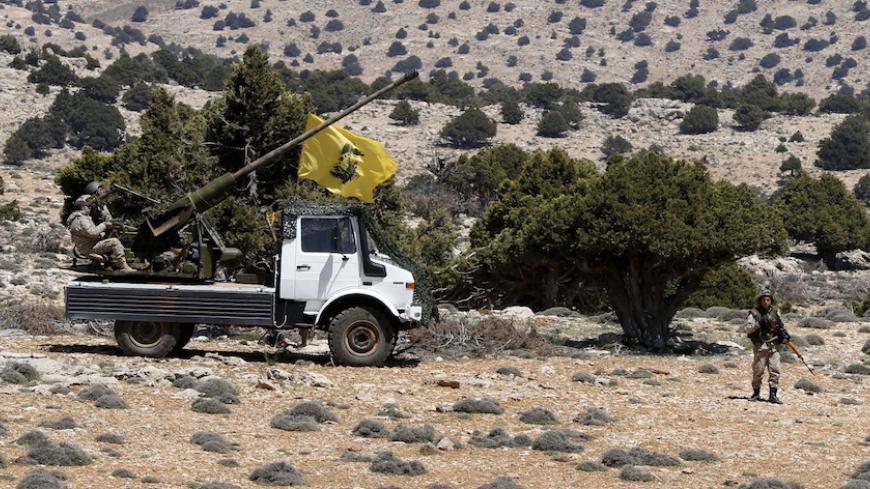 Lebanon's Hezbollah fighters rest on the back of a pick-up truck with an installed weapon in Khashaat, in the Qalamoun region after they advanced in the area May 15, 2015.  Lebanon's Hezbollah and Syria's army made big advances against insurgents in mountains north of Damascus on Wednesday, Hezbollah and Syrian state media said, shoring up President Bashar al-Assad's grip on the border zone. REUTERS/Mohamed Azakir - RTX1D54Z