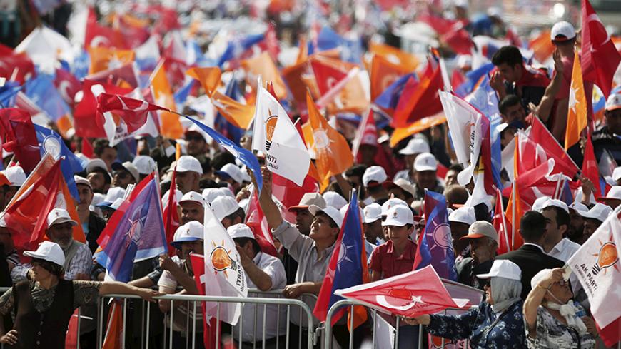 Supporters of Turkey's Prime Minister Ahmet Davutoglu wave Turkish and AK Party flags during an election rally for Turkey's June 7 parliamentary elections in Istanbul, Turkey, May 17, 2015.   REUTERS/Osman Orsal - RTX1DCCG