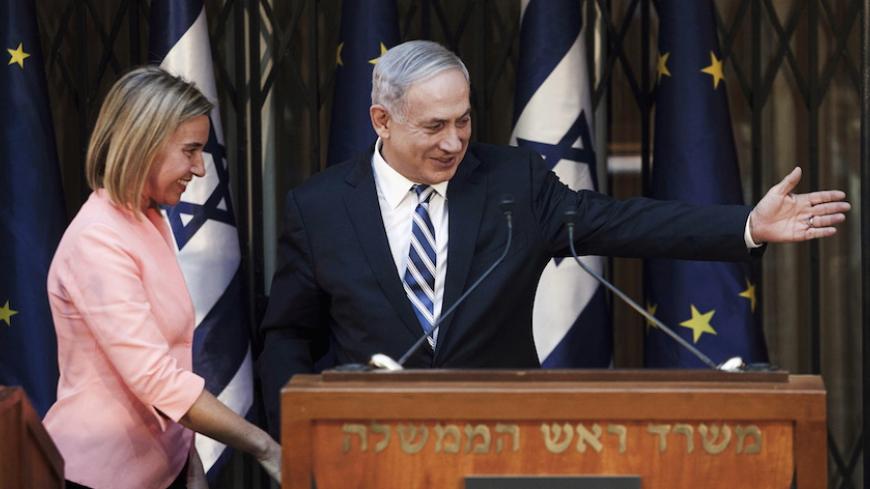 Israeli Prime Minister Benjamin Netanyahu (R) shows the way to European Union foreign policy chief Federica Mogherini during their meeting in Jerusalem May 20, 2015. Netanyahu renewed his commitment on Wednesday to a two-state solution of the Israeli-Palestinian conflict, after backtracking on that pledge during a heated campaign for a March election. REUTERS/Dan Balilty/Pool - RTX1DU9V