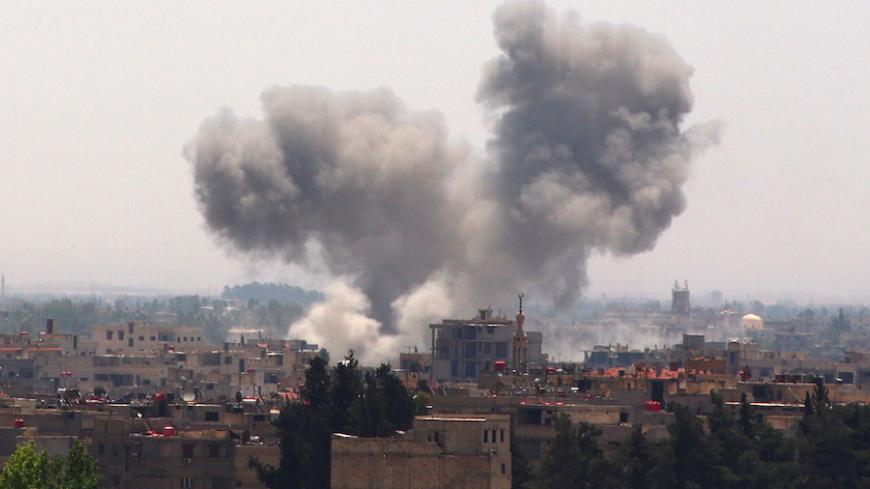 Smoke rises from what activists said was due to shelling by forces loyal to Syria's president Bashar Al-Assad on the outskirts of Damascus city in the eastern Damascus suburb of Ghouta May 21, 2015.  REUTERS/Diaa Al-Din  - RTX1DYKI