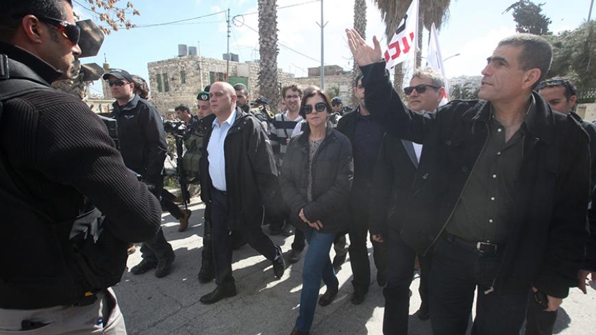 Israeli Meretz party members Nitzan Horowitz (2nd from R), Zehava Galon (C) and Issawi Frej (c-L) take part in a visit of the "Al-Shuhada" street in the West Bank city of Hebron on February 25, 2014 in support of Palestinians who were forced out of the old quarter at the outset of the second Palestinian intifada by the Israeli army to allow for Jewish settlers to move securely in the area. Today also marks the 20th anniversary of the massacre of 29 Palestinian Muslim worshipers by Jewish extremist Baruch Go