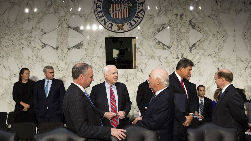 Senators John McCain (R-AZ) (center), Tim Kaine (D-VA) and Ben Cardin (D-MD) (right) speak before Chairman of the Joint Chiefs General Martin E. Dempsey, John Kerry, U.S. secretary of state, and Charles 'Chuck' Hagel, secretary of defense, arrive to present the administration's case for U.S. military action against Syria to a Senate Foreign Relations Committee hearing on September 3, 2013. President Barack Obama on Tuesday urged quick congressional action authorizing the use of military force against Syria