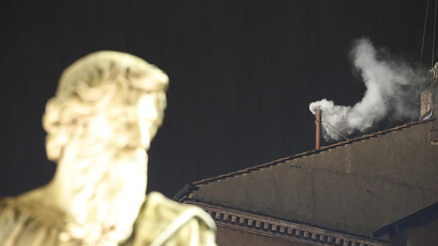 White smoke rises from the chimney above the Sistine Chapel in the Vatican, indicating a new pope has been elected at the Vatican March 13, 2013. White smoke rose from the Sistine Chapel and the bells of St. Peter's Basilica rang out on Wednesday, signaling that Roman Catholic cardinals elected a pope to succeed Benedict XVI. REUTERS/Tony Gentile (VATICAN - Tags: RELIGION) - RTR3EXR7
