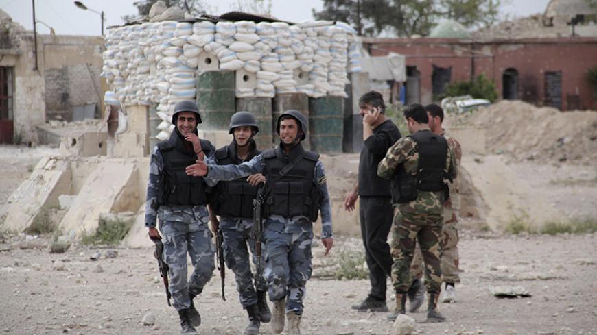 Forces loyal to Syria's President Bashar al-Assad  walk inside the government- controlled Hanano barracks after what they said was an offensive against them by Free Syrian Army fighters in Aleppo April 17, 2014. The regime forces said that Free Syrian Army fighters carried an offensive against them by digging a tunnel and blowing up part of the Hannano barracks in an attempt to seize it and failed to do so. REUTERS/George Ourfalian   (SYRIA - Tags: POLITICS CIVIL UNREST CONFLICT MILITARY) - RTR3LPQX