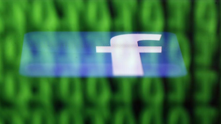 A Facebook logo on an Ipad is reflected among source code on the LCD screen of a computer, in this photo illustration taken in Sarajevo June 18, 2014. Ireland's High Court on Wednesday asked the European Court of Justice (ECJ) to review a European Union-U.S. data protection agreement in light of allegations that Facebook shared data from EU users with the U.S. National Security Agency. REUTERS/Dado Ruvic (BOSNIA AND HERZEGOVINA - Tags: CRIME LAW BUSINESS POLITICS) - RTR3UH6G