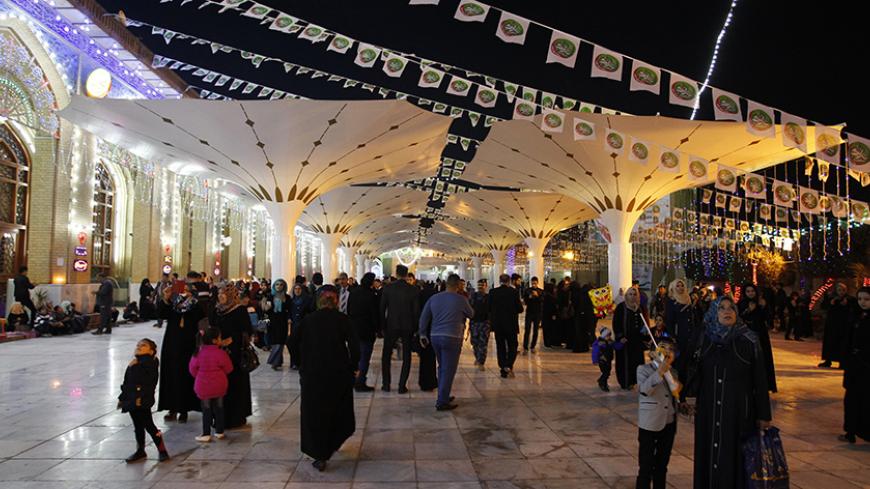 People gather at Abu Hanifa mosque during a celebration ceremony marking the birth anniversary of Prophet Mohammad, in Baghdad's Adhamiya district January 2, 2015. REUTERS/Thaier al-Sudani (IRAQ - Tags: RELIGION ANNIVERSARY) - RTR4JXAS