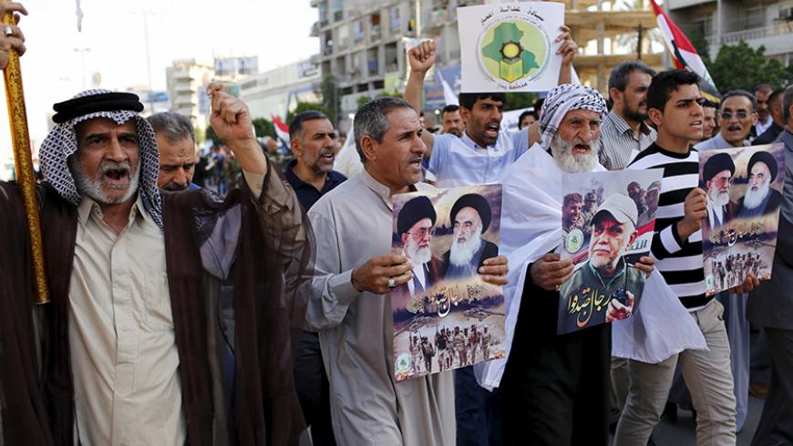 Iraqi men demonstrate in Baghdad, to show support for Yemen's Shi'ite Houthis and in protest of an air campaign in Yemen by a Saudi-led coalition, March 31, 2015. Saudi troops clashed with Yemeni Houthi fighters on Tuesday in the heaviest exchange of cross-border fire since the start of a Saudi-led air offensive last week, while Yemen's foreign minister called for a rapid Arab intervention on the ground. REUTERS/Thaier Al-Sudani - RTR4VNDE