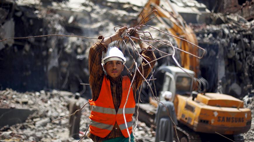 An Egyptian worker is seen during the demolition of the headquarters of former Egyptian President Hosni Mubarak's political party National Democratic Party (NDP) in Cairo, Egypt, June 1, 2015. Egypt began demolishing on Sunday the building that had housed the headquarters of former President Hosni Mubarak's political party, a symbol of decades of iron-fisted rule. REUTERS/Amr Abdallah Dalsh - RTR4YC91