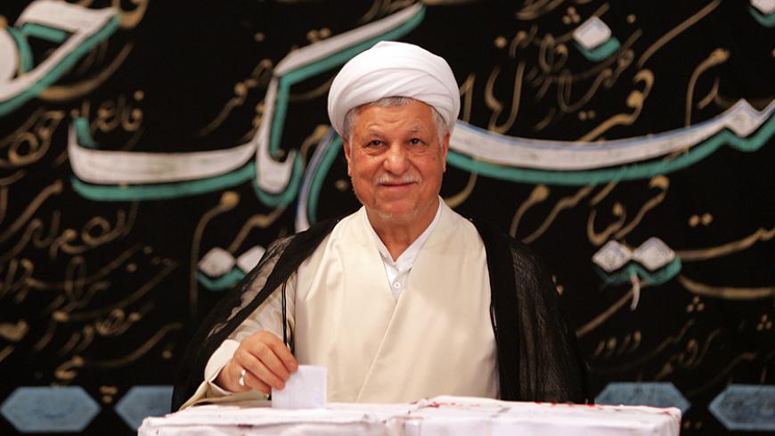 Former Iranian president and election front-runner Akbar Hashemi Rafsanjani casts his ballot in the Iranian presidential election in Tehran June 17, 2005. Iran holds presidential election on Friday under international scrutiny for its nuclear programme, its rocky relationship with the United States and by observers keen to see which direction the Islamic Republic will move in now that the presidency of reformist Mohammad Khatami has ended. REUTERS/Damir Sagolj  CJF/DY - RTREON2