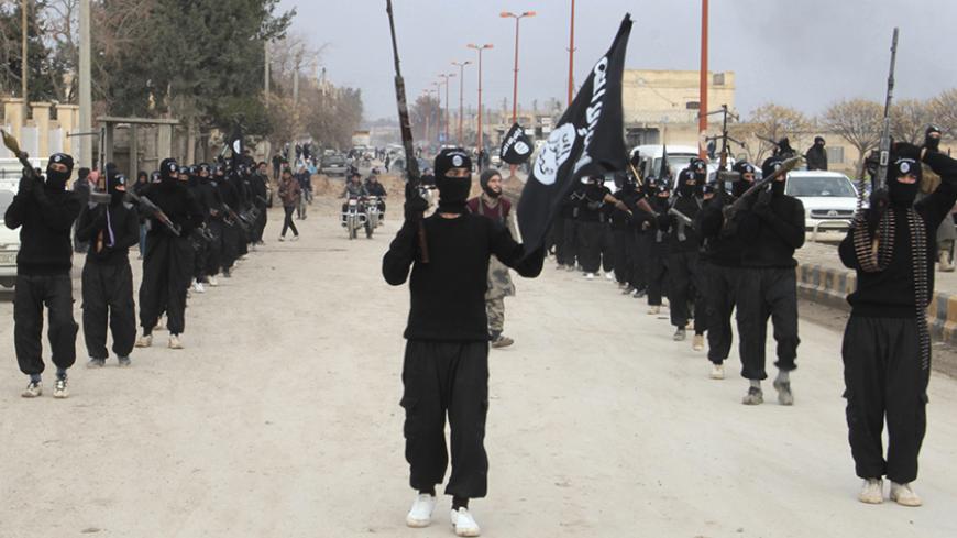 Fighters of al-Qaeda linked Islamic State of Iraq and the Levant carry their weapons during a parade at the Syrian town of Tel Abyad, near the border with Turkey January 2, 2014. Picture taken January 2, 2014. REUTERS/Yaser Al-Khodor (SYRIA - Tags: POLITICS CIVIL UNREST CONFLICT) - RTX170UI