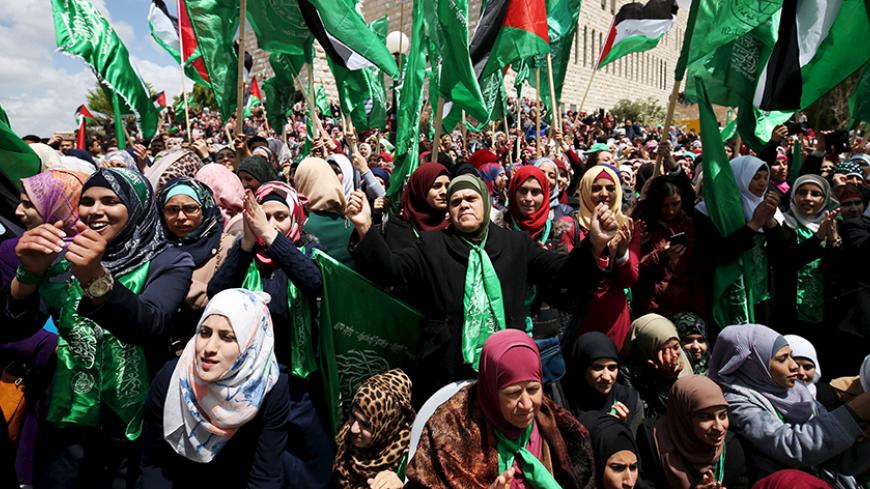 Palestinians supporting Hamas chant slogans during a rally celebrating Hamas student supporters winning the student council election at Birzeit University in the West Bank city of Ramallah April 23, 2015. REUTERS/Mohamad Torokman
- RTX19YL4