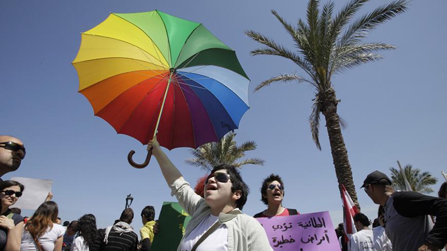 Lebanese activists chant slogans during a demonstration in front of parliament in Beirut April 25, 2010. Around 3,000 Lebanese marched in Beirut on Sunday to demand a secular system in place of the Muslim-Christian sectarianism that permeates politics,employment and family status matters in Lebanon. REUTERS/ Jamal Saidi   (LEBANON - Tags: CIVIL UNREST POLITICS) - RTXS512