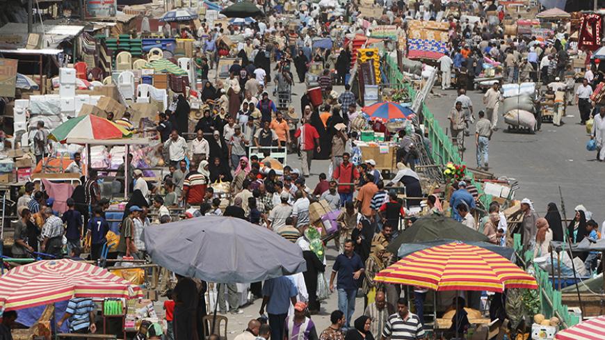 Iraqis shop at the Shorja market, the main stockpile central in Baghdad on August 30, 2008, as households prepare for the Muslim holy month or Ramadan. Iraqi women and men once fearful of shopping here are more confident since the improvement in security around the capital. Muslims around the world are gearing up for the holy month of Ramadan which commences on Sept 01. For the duration of the lunar month, Muslims are required to abstain from food, drink and sex from dusk till dawn as life slips into a lowe