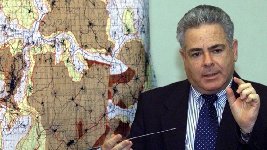 Deputy Defense Minister Ephriam Sneh in front of a large map of the West Bank during a press conference March 19 at which he announced the Israeli cabinet decision to go ahead with a further redeployment from 6.1% of West Bank land to be handed over to full Palestinian Authority. control. The dark brown areas show areas to be included in the redeployment in the northern part of the West Bank. The Palestinians will control 60% of their population but only a bit less than 20% of the West Bank land after the 6