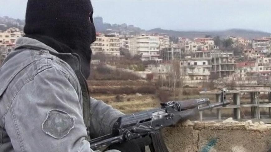 EDITOR'S NOTE: REUTERS CANNOT INDEPENDENTLY VERIFY CONTENT OF VIDEO FROM WHICH THIS STILL IMAGE WAS TAKEN.

A member of the Free Syria Army with an assault rifle stands guard during a patrol in the western border town of Zabadani in this undated still image taken from amateur video obtained by Reuters January 16, 2012. Masked gunmen prowl the rain-swept streets of the once-relaxed Syrian hill resort, which they have transformed into a hub of revolt against President Bashar al-Assad's rule. Zabadani, hugging