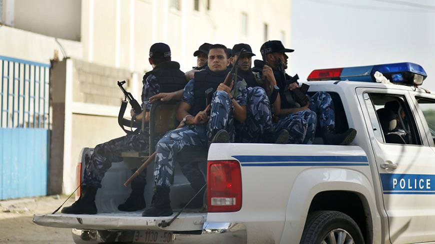 Hamas policemen guard outside a Gaza military court September 17, 2012. The court on Monday handed out rulings against four Palestinians involved in the kidnapping and killing of an Italian pro-Palestinian activist, Vittorio Arrigoni, in 2011, sentencing two of them to life imprisonment, witnesses said. Of the remaining two, one was sentenced to 10 years and the other one year in prison. REUTERS/Mohammed Salem (GAZA - Tags: POLITICS CRIME LAW) - RTR382IQ